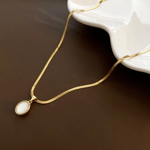 Elegant gold flat snake chain necklace with a white shell teardrop pendant
