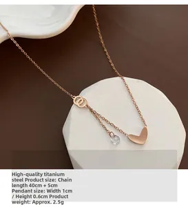 Detail of rose gold heart pendant with zircon on white stone stand, quality titanium steel