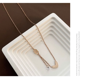 Macro detail of rose gold heart pendant necklace with zircon stone on white display