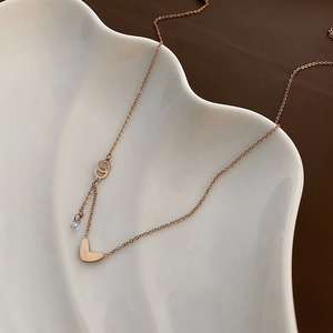 Rose gold heart pendant necklace with zircon stone on shell plate display