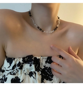 Dettaglio della collana asimmetrica con perle di ossidiana nera e cristalli bianchi