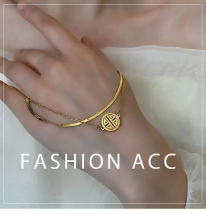 Double-layered gold titanium steel bracelet featuring a flat snake chain and round pendant