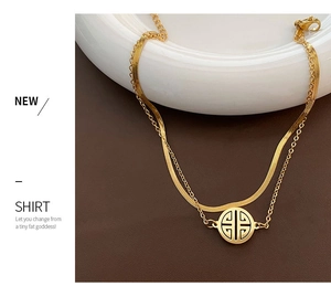 Detailed close-up of double-layered gold titanium anklet with round hollow pendant