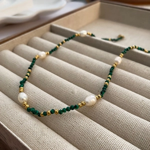 Handmade necklace with natural pearls and green turquoise beads in a jewelry box