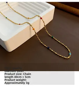 Detail of gold titanium steel necklace featuring colorful beads and 40+5cm length