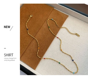 Detail of colorful enamel beads on gold-plated stainless steel necklace with K18 tag