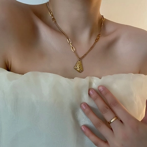 Gold-plated titanium steel portrait pendant necklace with pearl on asymmetric chain