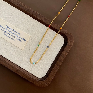 Chic gold titanium steel necklace with colorful beads on a premium display tray