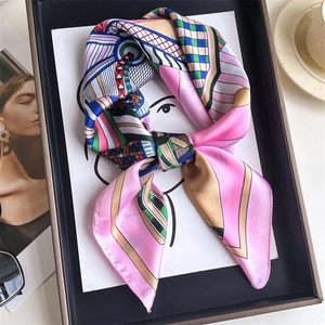 Detailed view of tied 70cm silk scarf featuring colorful geometric block patterns