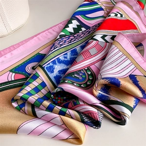 Close-up of luxury silk scarf showing vibrant geometric patterns and soft texture