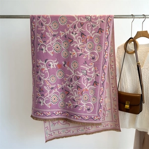 Close-up of purple floral cashmere shawl with intricate jacquard weave and tassels