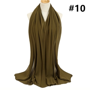 Detail of olive green chiffon hijab scarf draped elegantly to show soft fabric texture