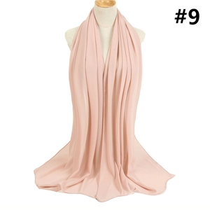 Detail of light pink bubble chiffon scarf fabric texture on a mannequin torso