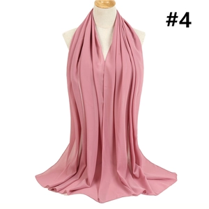 Detail of pink chiffon hijab showing soft fabric texture and elegant drape on a mannequin