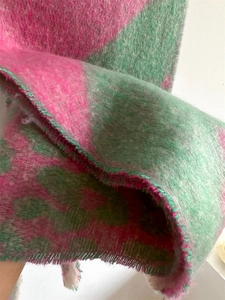 Detail of soft mohair texture and fringe edge on pink and green block scarf