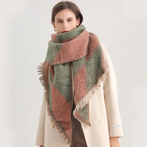 Detail of red and green checkerboard scarf with thick cashmere texture and fringe edges