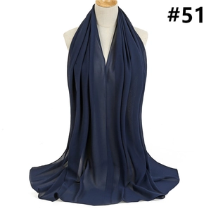 Detailed texture of dark blue lightweight chiffon scarf draped with natural folds