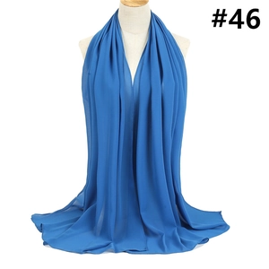Detail view of royal blue chiffon shawl with elegant texture on a display mannequin