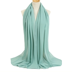 Detail of mint green chiffon scarf showing the lightweight fabric texture on a mannequin