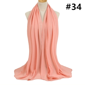 Detail of peach bubble chiffon hijab showing soft texture and premium hemmed edges