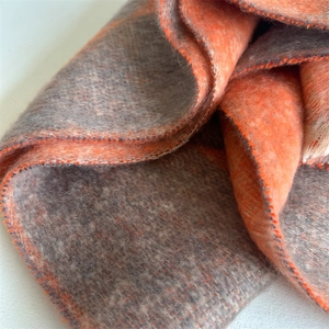 Detail shot of orange and grey checkerboard scarf with soft brushed cashmere-like texture