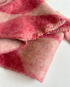 Close-up of soft pink and beige checkered cashmere scarf with fringe details