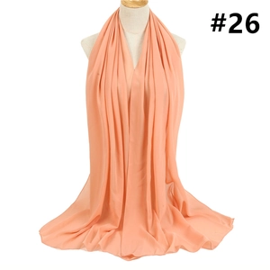 Close-up of coral orange bubble chiffon hijab with soft texture and elegant drape