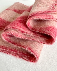 Close-up of pink and beige striped faux cashmere scarf showing plush brushed texture