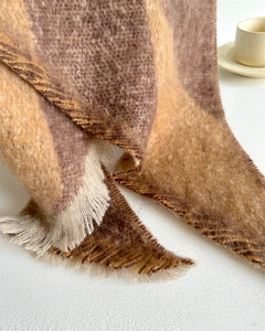 Detail of warm checkered scarf with soft fringe and thick cashmere-like texture