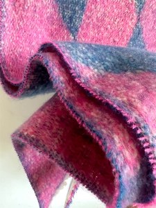 Close-up of pink and blue checkerboard scarf showing soft faux cashmere texture and stitching
