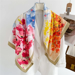 90cm floral silk scarf with colorful flower print and contrast border over a white blazer