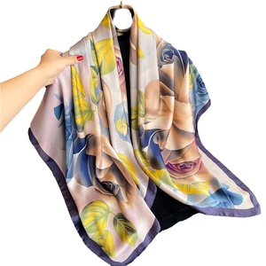 Satin silk scarf featuring romantic large rose floral patterns in yellow and royal blue
