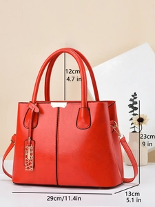 Elegant red faux leather handbag with golden hardware and adjustable strap in 29cm size