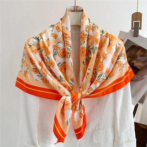 Elegant floral print square silk scarf with orange flower patterns on cream background