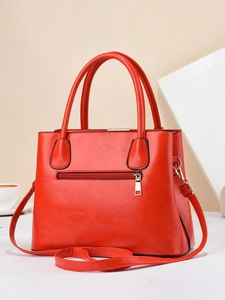 Red PU leather tote bag with top handles, front zipper pocket and adjustable shoulder strap