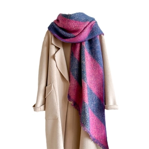 Thick pink and blue checkered cashmere scarf with fringe paired with beige coat