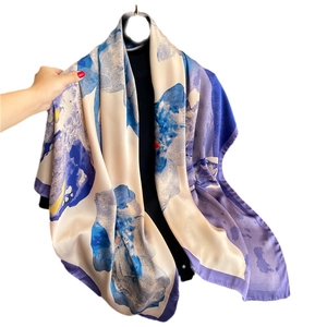 Lustrous floral satin scarf with blue and purple abstract prints in a silky drape view