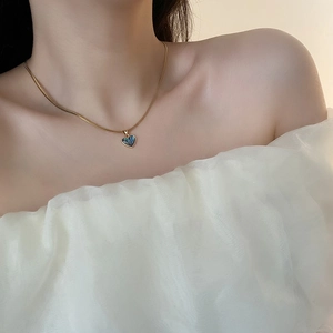 Exquisite gold heart necklace with abalone shell pendant on a flat snake bone chain