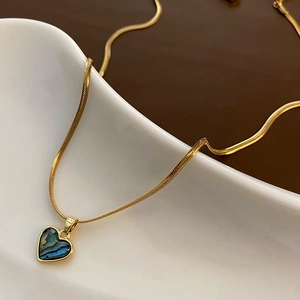 Elegant gold snake chain necklace with an iridescent abalone shell heart pendant