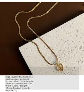 Detail of hollow heart rose pendant in gold-plated steel with dimensions 1.1x1.14cm
