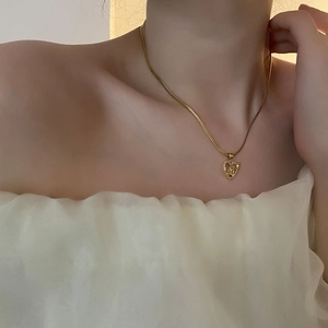 Elegant gold heart and rose pendant necklace with zircon detailing on dainty snake chain