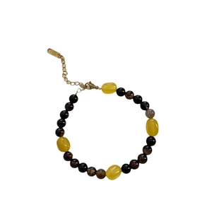 Handmade beaded necklace with translucent yellow stone and dark round beads with gold clasp