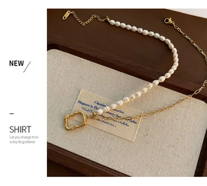 Close-up of pearl and gold chain necklace with a hammered square pendant on linen
