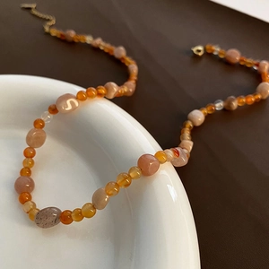 Collana artigianale di perle di cristallo fragola con ciondolo S e chiusura in titanio