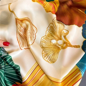 Artistic ginkgo leaf silk scarf shawl with vibrant golden and green foliage patterns