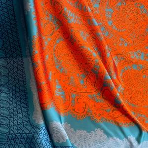 Luxurious orange and light blue patterned silk scarf with intricate mandala motifs