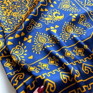 Blue and gold silk shawl with paisley patterns shown in artistic draping style