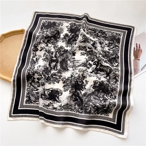 Detailed view of the square silk scarf with black and white Toile de Jouy animal print