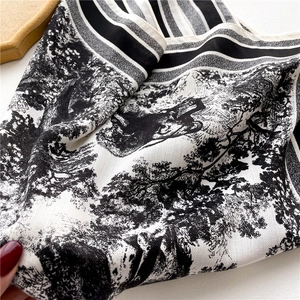 Close-up of black and white Toile de Jouy silk scarf with herringbone weave details