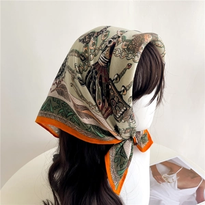Close-up of vintage silk scarf with herringbone pattern and orange borders on head